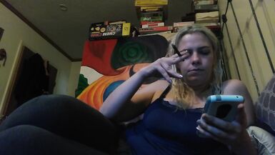Hot blonde smokes clove cigarettes, plays on phone and plays with tits - 2 image