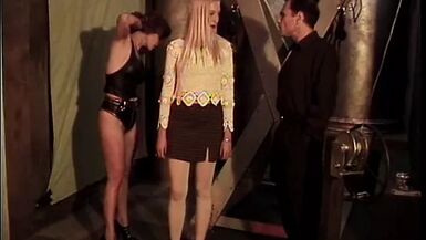 Sexy blonde is bound in red and has clamps applied by sadist