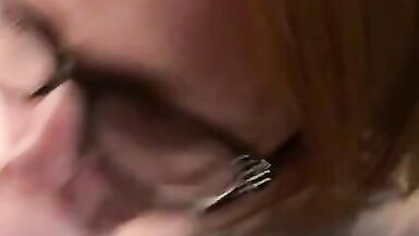 Hot redhead wearing glasses gets a facial - 15 image