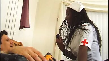 Hot black nurse in stockings gets pounded and creamed by a white dude in bed - 1 image