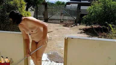Nude housewife cleaning the balcony - 1 image