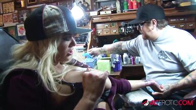 Shyla Stylez gets tattooed while playing with her tits - 1 image