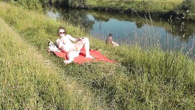 Wild beach. Sexy MILF Platinum naked sunbathing on river bank, random fisherman guy watches. Naked in public. Nude beach - 14 image