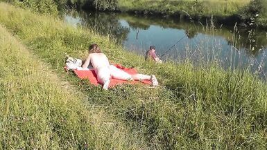 Wild beach. Sexy MILF Platinum naked sunbathing on river bank, random fisherman guy watches. Naked in public. Nude beach - 15 image