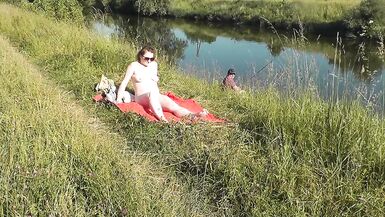 Wild beach. Sexy MILF Platinum naked sunbathing on river bank, random fisherman guy watches. Naked in public. Nude beach - 3 image
