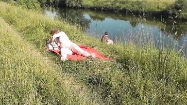 Wild beach. Sexy MILF Platinum naked sunbathing on river bank, random fisherman guy watches. Naked in public. Nude beach - 7 image