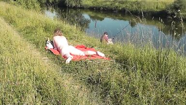 Wild beach. Sexy MILF Platinum naked sunbathing on river bank, random fisherman guy watches. Naked in public. Nude beach - 9 image