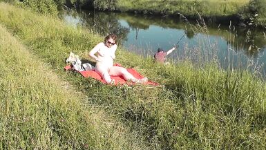 MILF sexy Frina on river bank undressed and sunbathes naked. Random man fisherman watching for her, and in the end decided to join naked woman. Wild beach. Nudist beach. Public nudity. Public exposure. Naked in public - 3 image