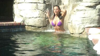 Romantic couple make out passionately by the poolside