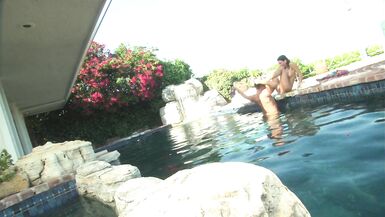 Romantic couple make out passionately by the poolside - 9 image