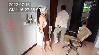 Nudist barbershop. Nude lady hairdresser in an apron makes client to strip. Security camera. The client is surprised. real spy cam 1 - 3 image