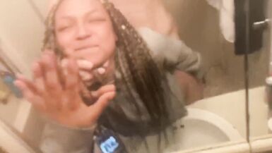 Blasian bent over bathroom sink while roommates in other room - 3 image