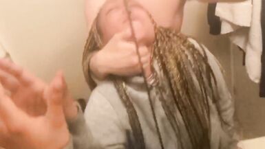 Blasian bent over bathroom sink while roommates in other room - 4 image
