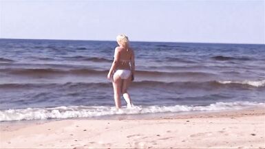 Hot MILF in a white bikini on the beach - 3 image