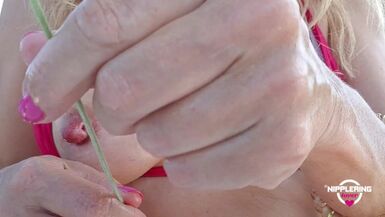 nippleringlover horny milf inserting lavender through extreme stretched pierced nipples close up - 1 image