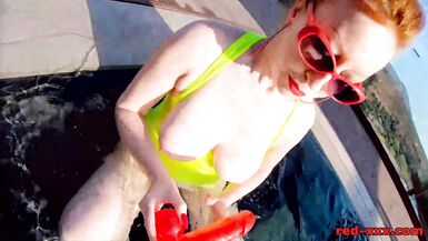 Red XXX fucks her pussy with a toy in the pool - 13 image