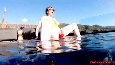Red XXX fucks her pussy with a toy in the pool - 14 image