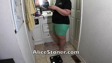 Big girl gets on a scale to measure her fat and curves with a tape. Weight gain video V139 - 2 image