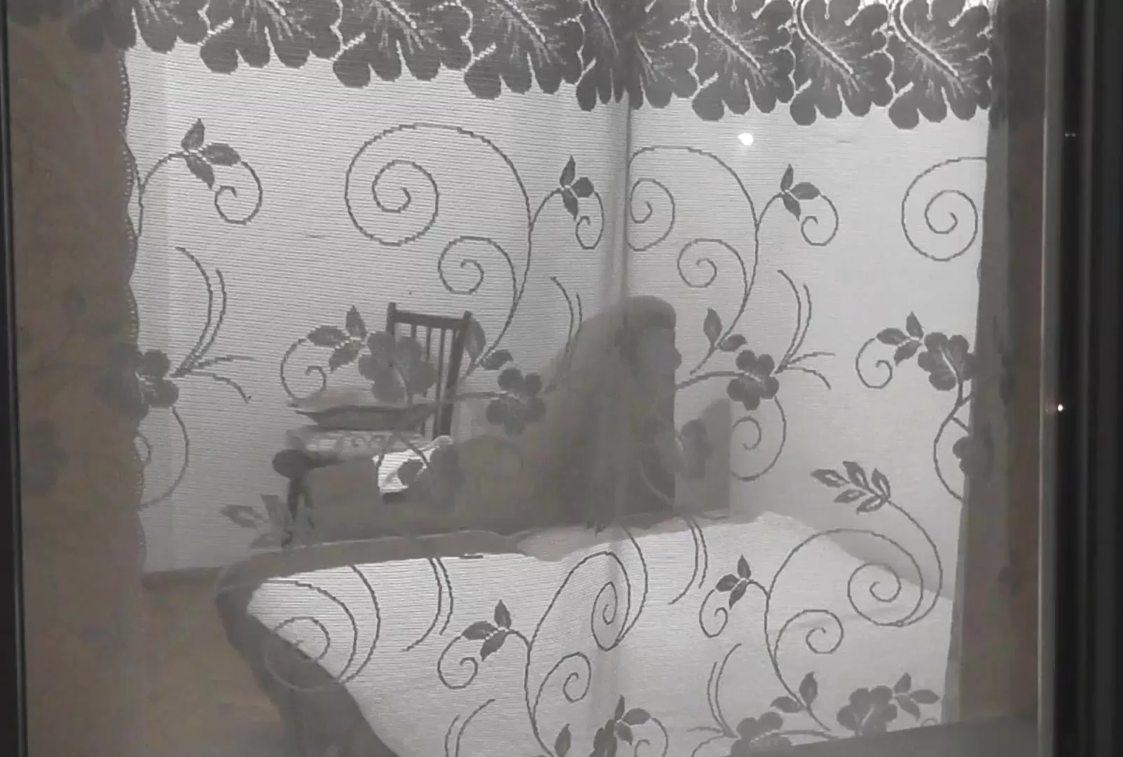 Peeping. Spy. Spying. Voyeur. Neighbour chap in evening looks into bedroom  window of a nude woman