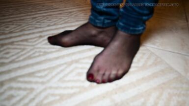 Feet in black stockings and jeans - 3 image