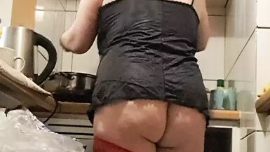 Wife in kitchen teasing husband to have sex while he watches - 1 image