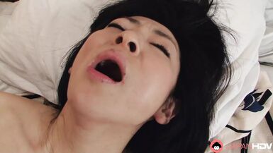 Japanese brunette Milf Emiko Koike blows her husband's hard cock uncensored. - 1 image