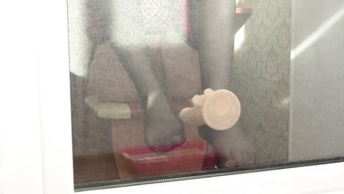 MILF neighbor caught fingering herself while playing with dildo by balcony door