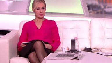 Lengthy legged tv host in dark hose and heels 10 - 1 image