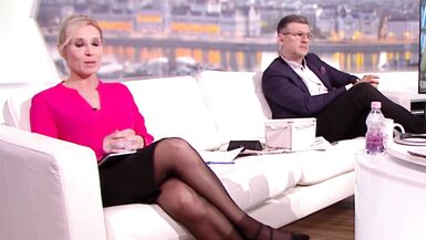 Lengthy legged tv host in dark hose and heels 10