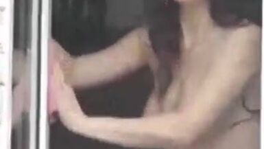 Filmed a naked neighbor as she washes the window