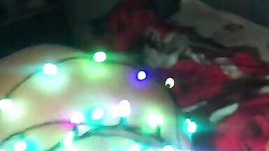Mon mari ma enveloppée dans des guirlandes lumineuses en guise de cadeau et je lai branlé avec mes pieds.