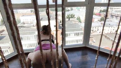 I'm playing with a pussy near a larger window